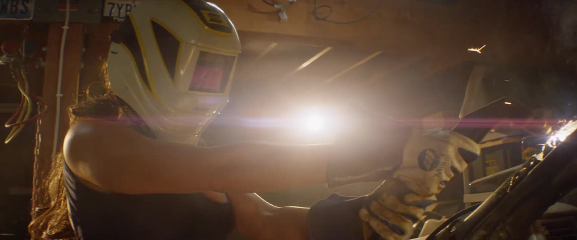 A mechanic is working on a vehicle in the garage