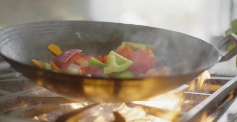 Vegetables being stir fried in a wok