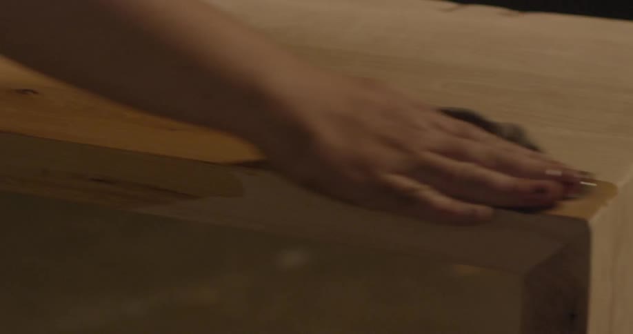 Person applying finish to a wooden surface