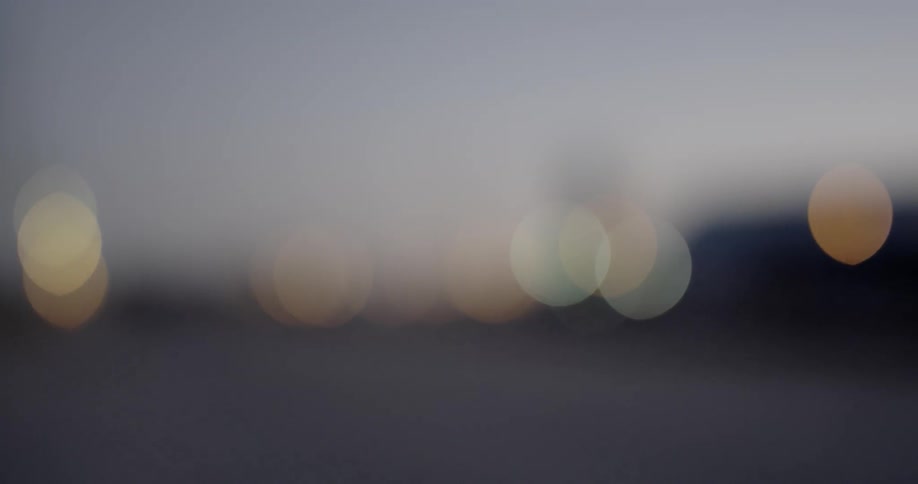 Lights are shining on a horizon at dusk