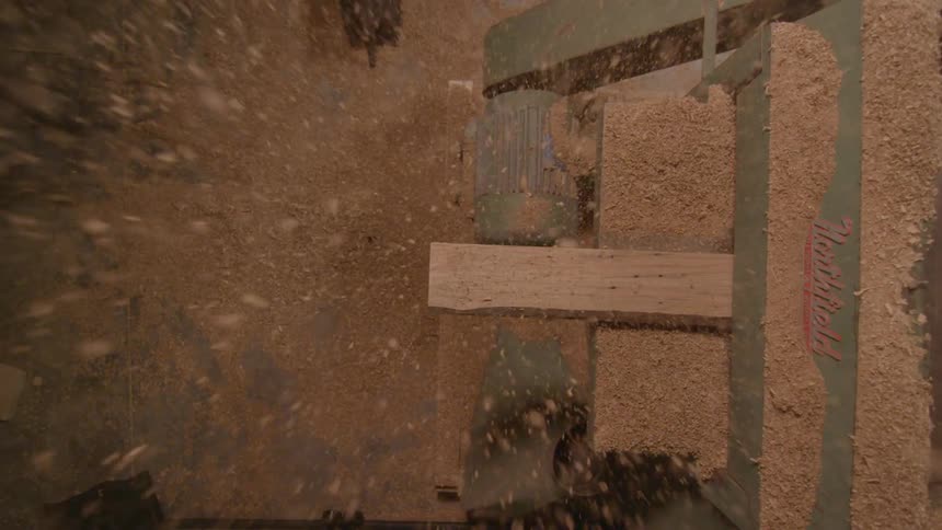 A man is cutting boards