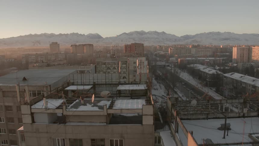The city ahead is full of buildings as the sun sets