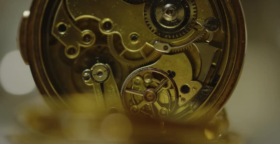 The gears of a clock moving