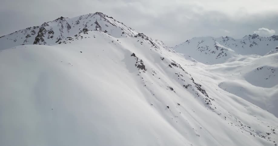 Snow covers the tall mountains