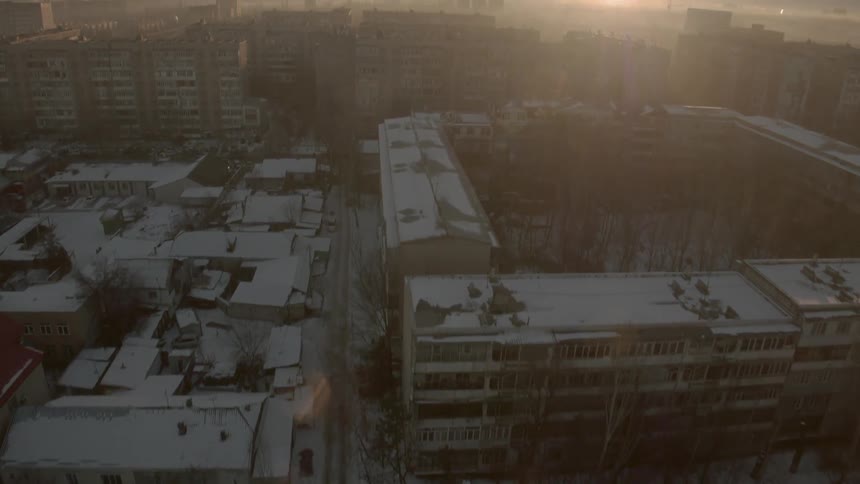 The buildings and lots below are covered with snow