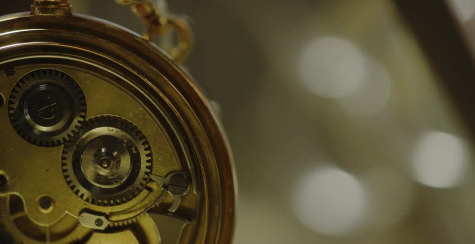 A pocket watch mechanism ticks inside the casing