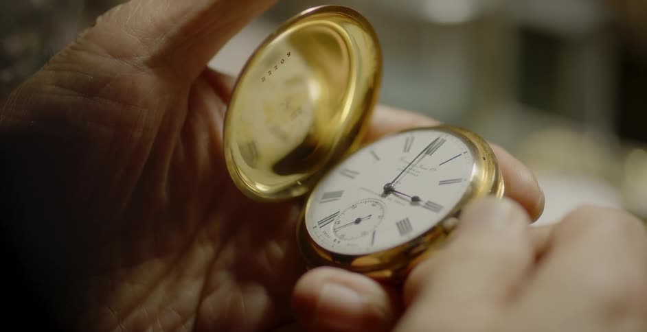 A person opens a pocket watch