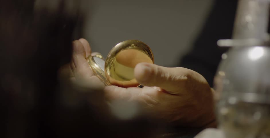 A man holds a pocket watch
