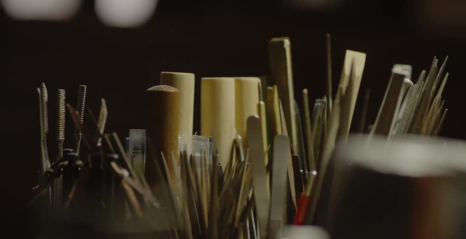 small tools and brushes sit on a table top