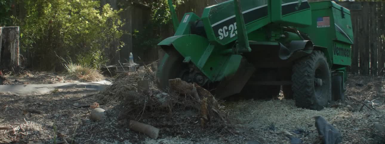 A stump is ground by a large saw