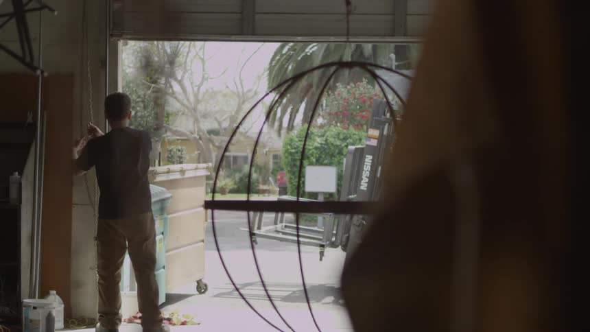 A man is opening his garage