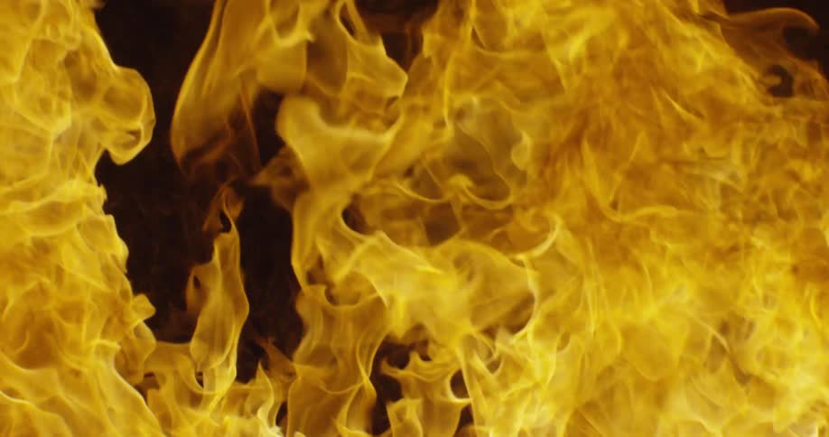 The fire blazes lighting up the dark area