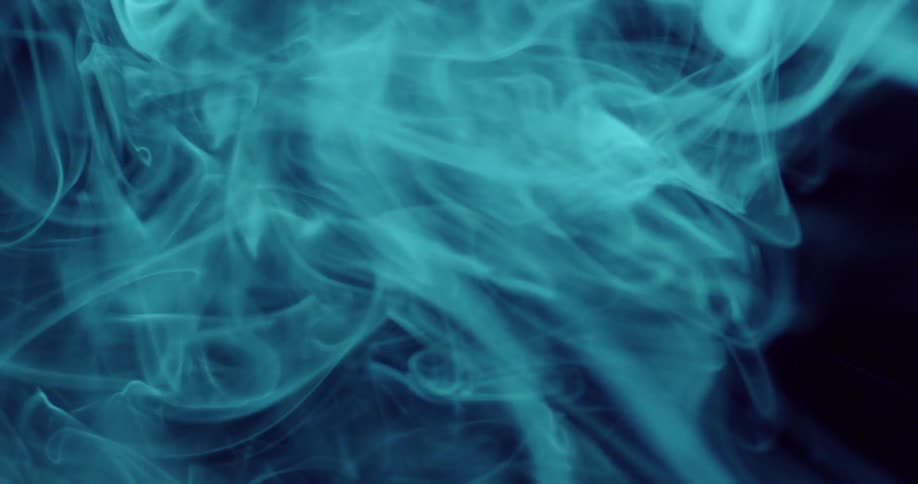 Blue smoke is swirling around against a black background