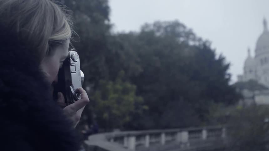 Someone is using a camera to take pictures of old buildings