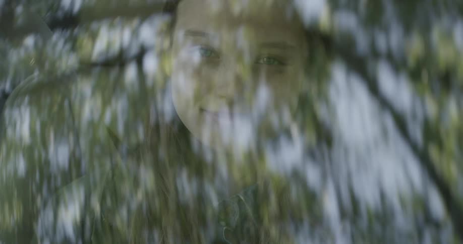 A young girl smiles while riding in a car