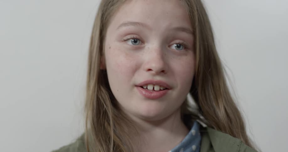 A child is giving a speech as she smiles