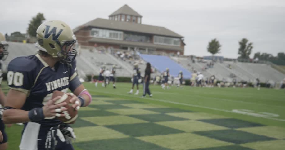 Football players warm up on field