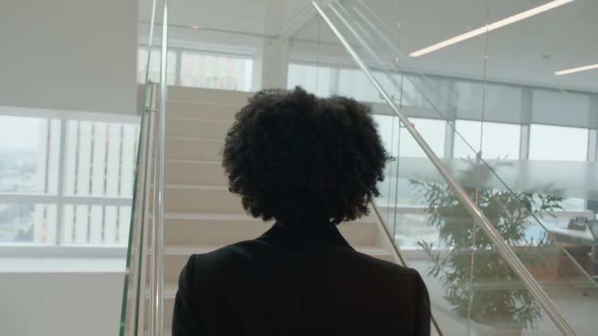 Woman ascends a white staircase