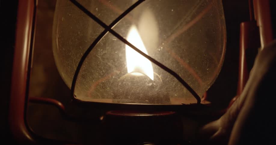 A gas lantern is turned on in the dark