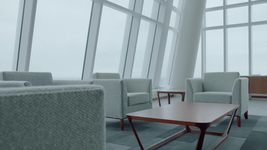 White chairs and tables sit in an office waiting room
