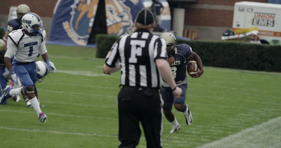Football players compete on an outdoor field