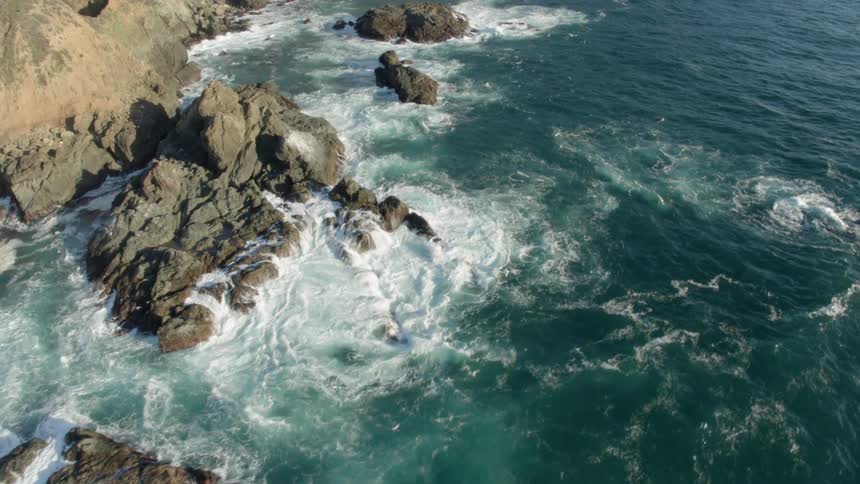 Waves crash onto the rocky shore