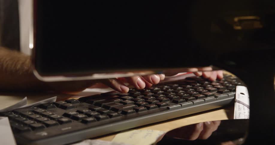 A person is working at their computer typing