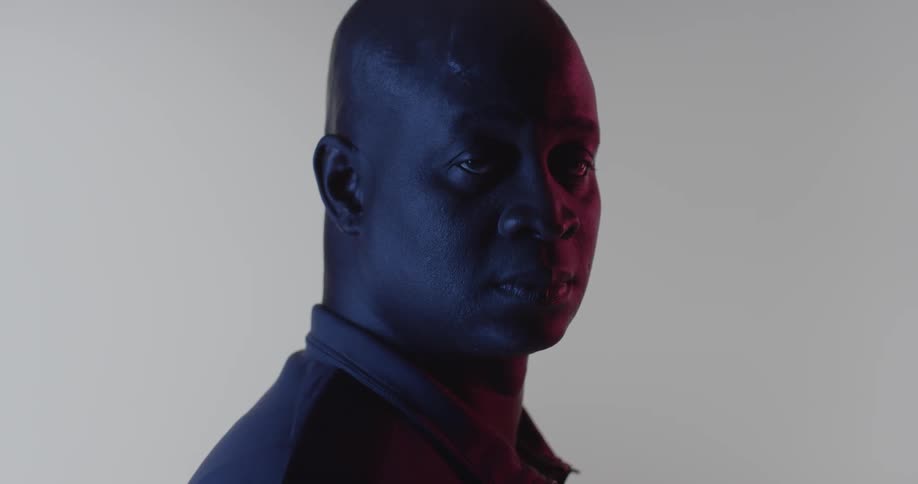 A man turns slowly in the dark