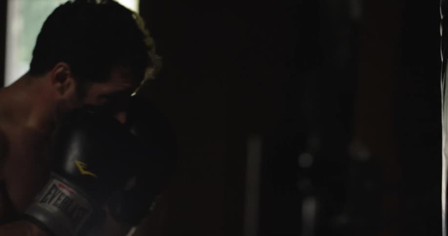 A boxer hits a heavy bag in training