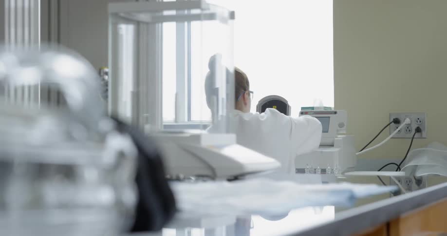 Lab technician works at their bench