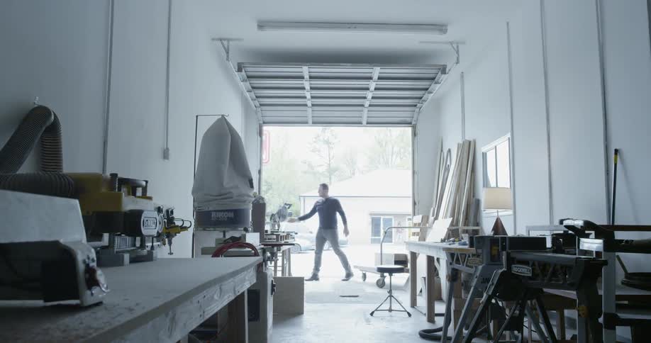 A man opens a garage door