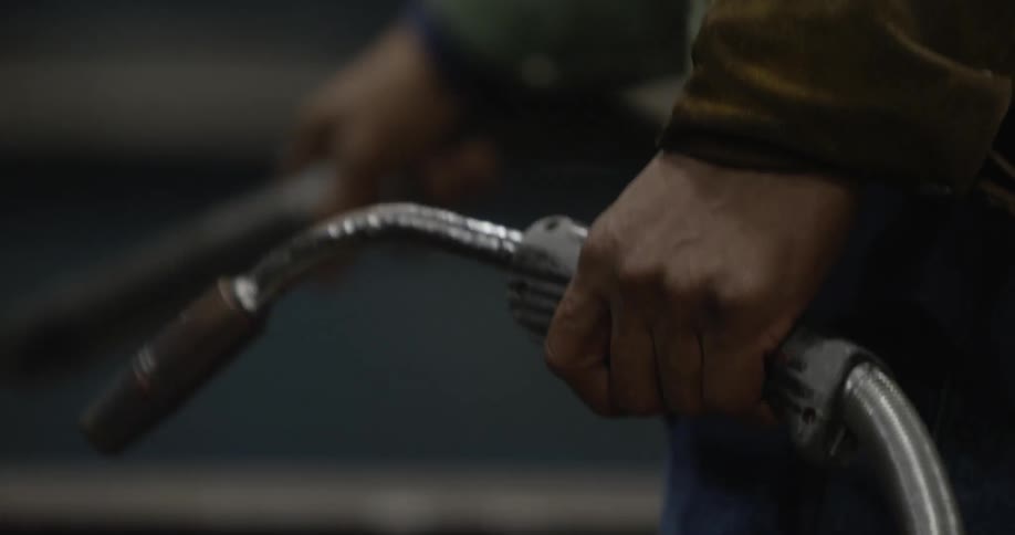 A man is using a piece of equipment in a factory