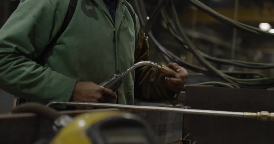 A welder works in a factory