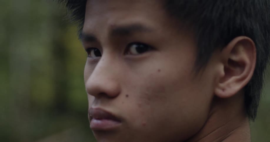 A man turns to look over his shoulder