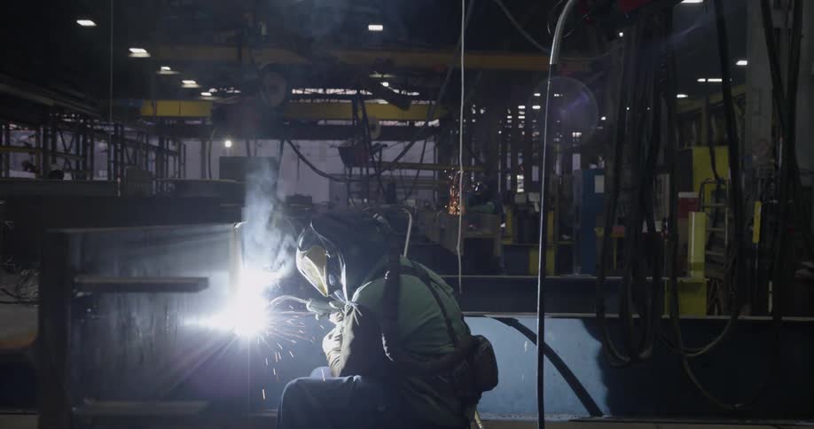 A welder works in a factory