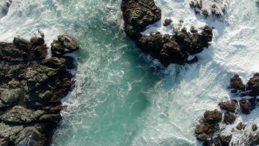 The water is rough below on the shore