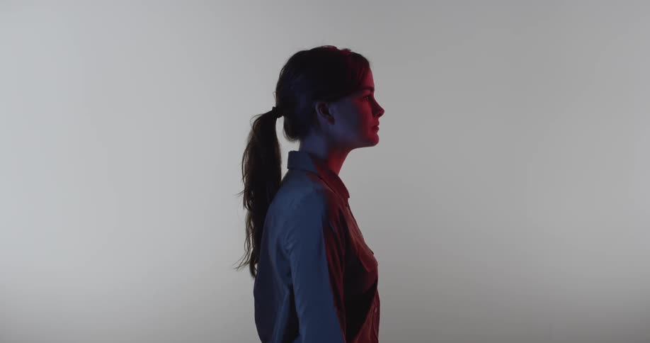 A woman stands completely still
