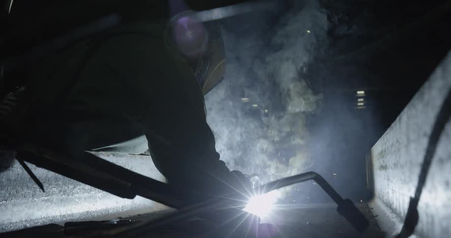A man welds a steel beam