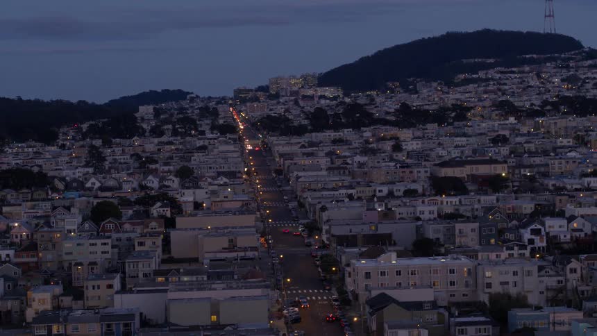 Vehicle lights illuminate the city road at night