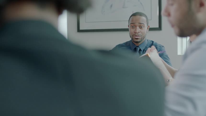 People have a business meeting in a conference room