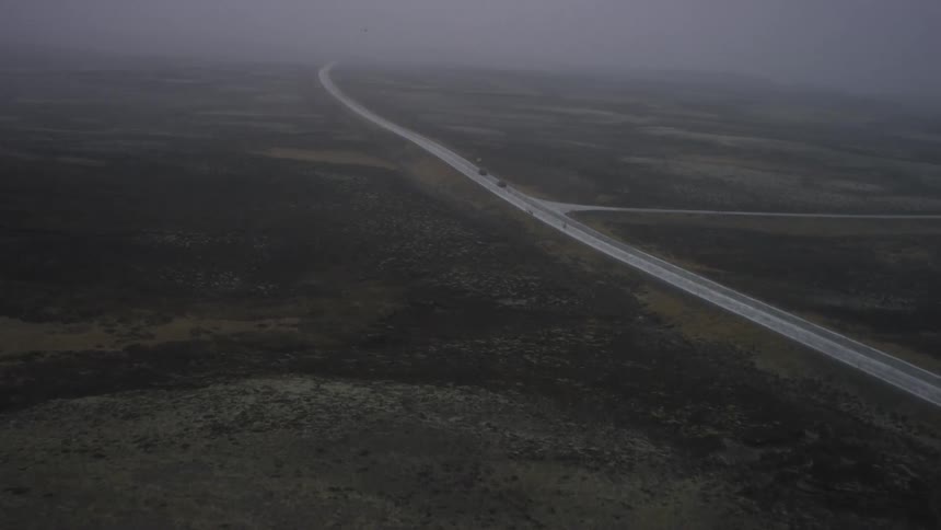 Vehicles travel down a remote road