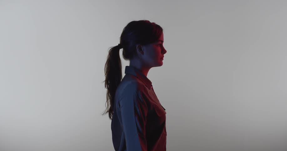 Pony tailed woman looking forward with a serious tone