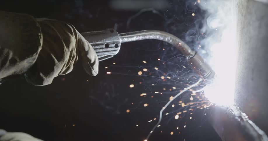 A person is welding metal with a torch