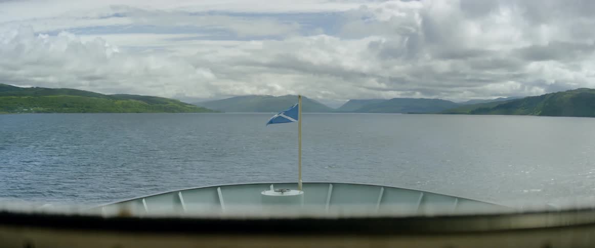 A blue and white flag flies on the ship