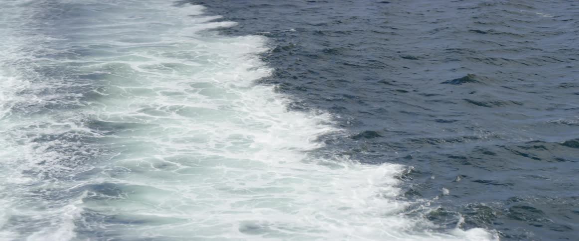 The waves move and splash in the ocean