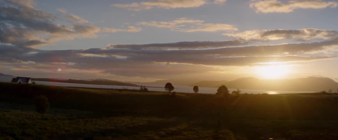 The sun shines on the shore as the sun sets