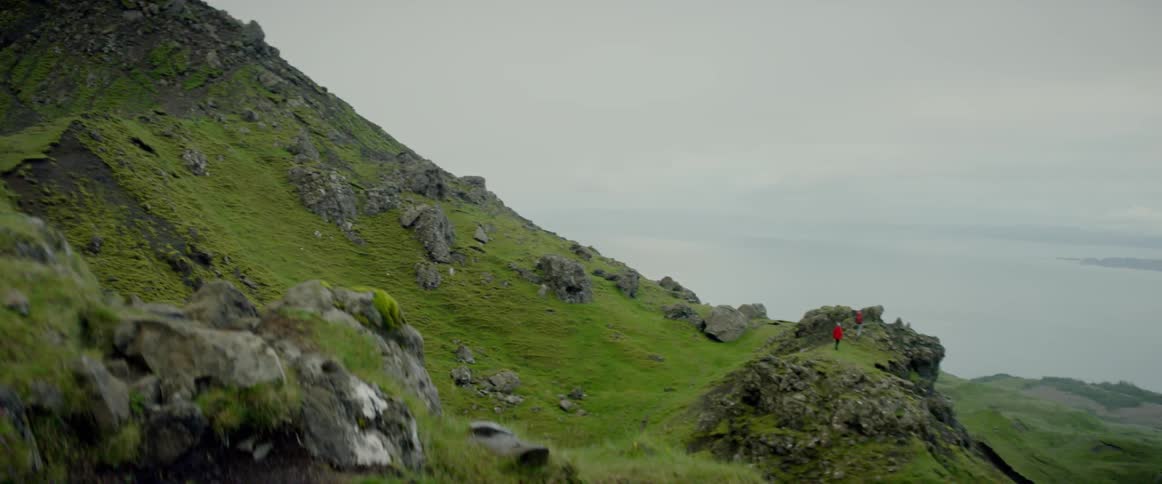 Rocky grassy hillside near a body of water