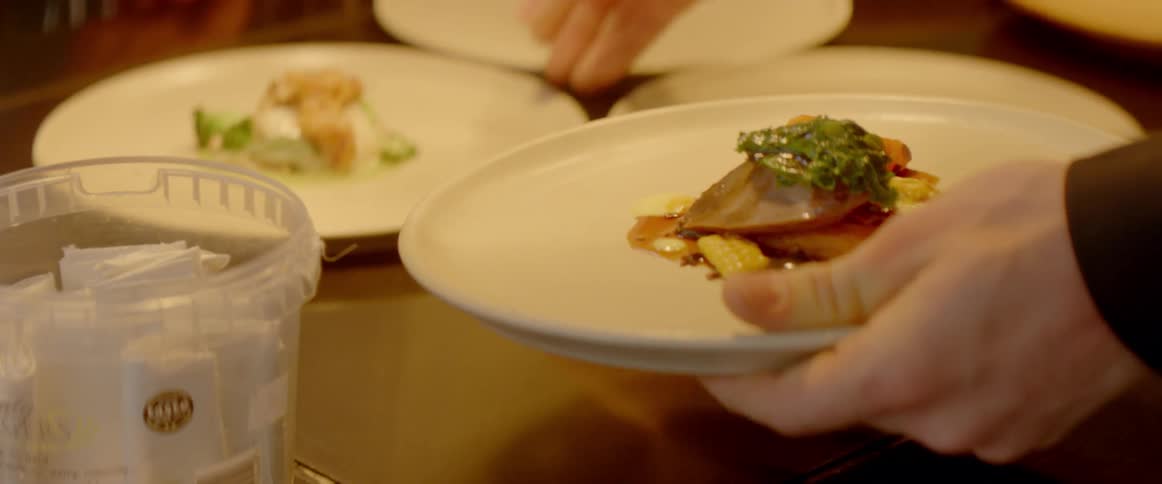 A plates of food are being picked up for service