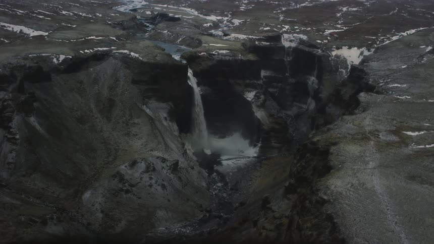Aerial view of the top of mountains with a waterfall