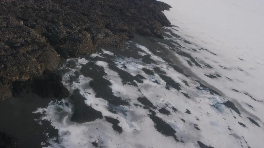 Waves are crashing on the rocks